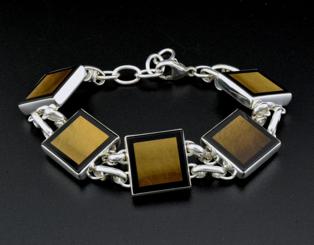 Cecilia Minnehan: Mother of Pearl and tiger eye inlay together and set in sterling silver. 
